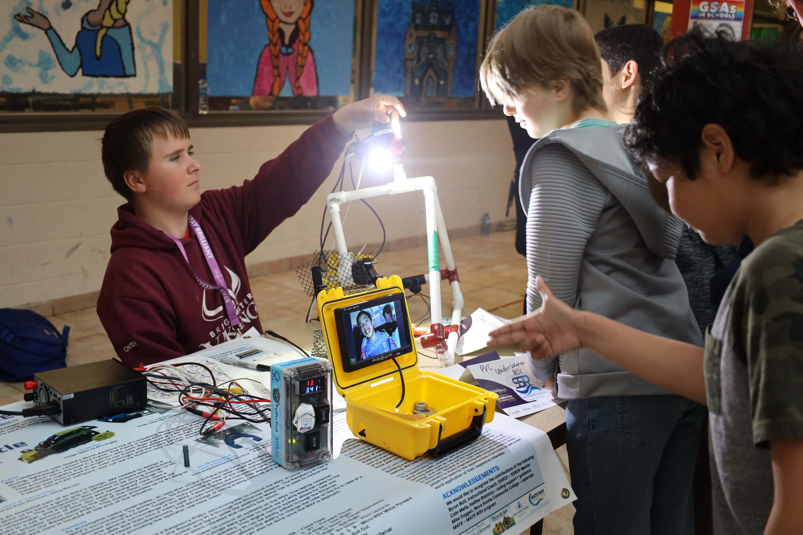 Youth working with pieces of marine technology.