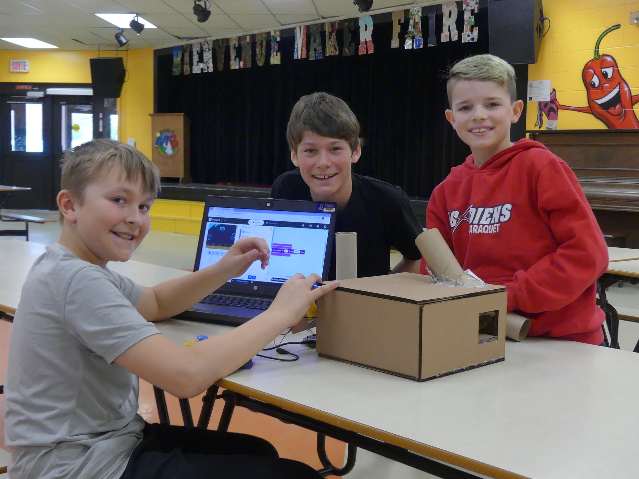 Youth working on a scratch project with cardboard