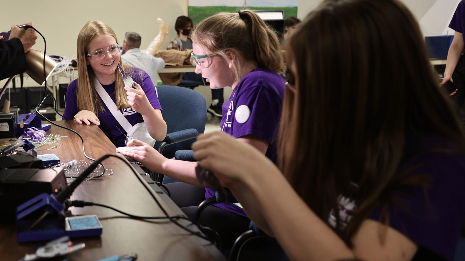 Youth soldering in a classroom